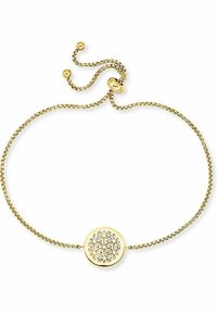 Guldbandet har en texturerad kedja och en rund, filigranmitten med ett blommönster. Justerbart glidlås för en säker passform.