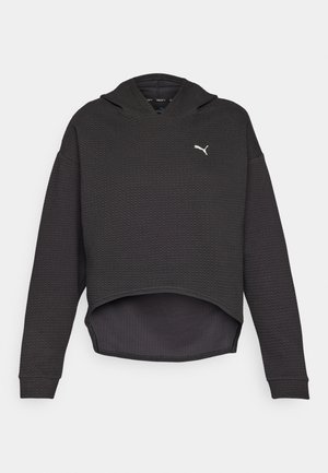 Black cropped hoodie with a textured fabric, featuring a hood and white logo on the chest. Long sleeves and a rounded hem.