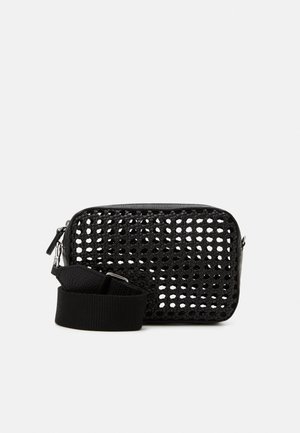 Black rectangular crossbody bag with woven open-knit front panel and adjustable wide fabric strap on a white background.