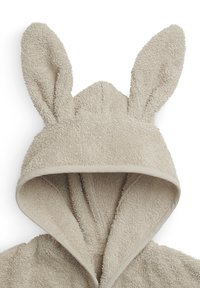 Hoodie en serviette beige avec un tissu texturé, featuring des oreilles de lapin surélevées sur la capuche et une ouverture à l'avant. Le matériau doux ajoute du confort.