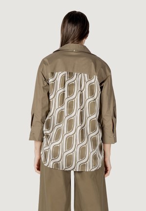 Camicia a maniche lunghe con il davanti color khaki e il retro con motivo che presenta disegni geometrici bianchi e beige. Realizzata in un tessuto liscio con colletto.
