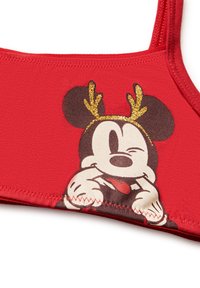Červené tílko z látky s kreslenou postavičkou se zlatými parůžky a hravým výrazem. Ploché švy a kulatý výstřih.