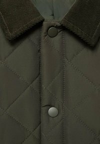 Quilted jacket in dark olive green, featuring a corduroy collar and black button closure, with a smooth, slightly glossy fabric texture.