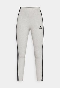 Grå leggings i bomullsblandning med svarta sidostripes, hög midja design och liten svart Adidas-logotyp på övre vänstra låret.