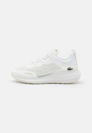 White low-top athletic sneaker with mesh and synthetic overlays, lace-up closure, cushioned sole, and small black crocodile logo on the heel.