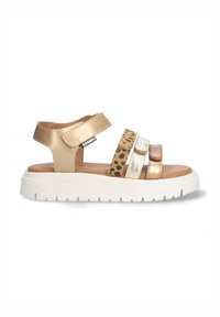 Gold and metallic strappy sandals with a leopard print accent, white thick sole, adjustable strap, and smooth leather texture.