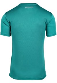 Teal, short-sleeved fitness shirt made of textured fabric. Features a round neckline and "GORILLA WEAR" logo at the back.
