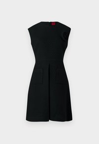 Black dress with a textured pattern, cap sleeves, two front pockets, and a floral accent detail on the shoulder. Back zipper closure.