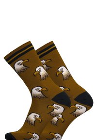 Braune Baumwollsocken mit wiederholten Adlerkopfdesigns, schwarzen Zehen- und Fersenakzenten sowie gelben gestreiften Bündchen oben.