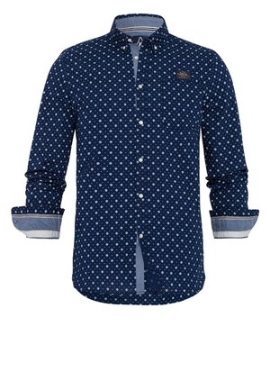 Mörkblå knapp-up skjorta med vitt små stjärnmönster, lång ärm med kontrasterande manschetter och en bröstpatch-logotyp. Tillverkad av tyg.