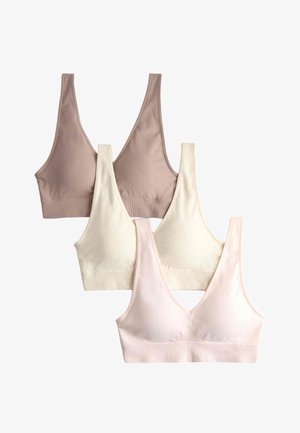 Set van vier zachte, draadloze, naadloze bralettes in beige, crème en lichtroze met brede bandjes en V-hals ontwerp.