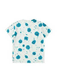 Kortärmad vit bomull t-shirt med ett lekfullt blått grafiskt mönster av smiley-ansikten och stänk. Avslappnad passform, rundad halsdesign.