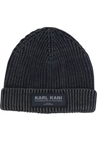 Black ribbed knit beanie with a folded cuff. Features a fabric label reading "KARL KANI" and additional text. Textured fabric for warmth.