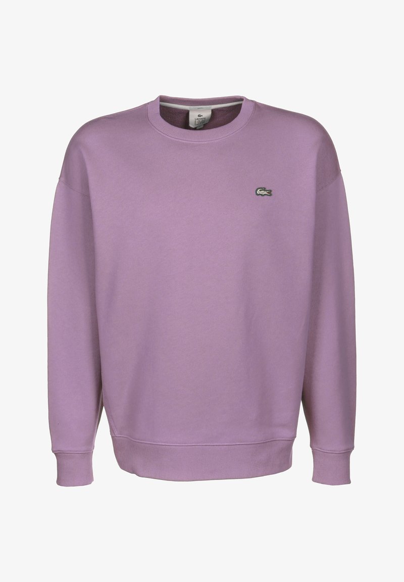 Lila pyöreäkauluksinen collegepaita, joka on valmistettu pehmeästä kankaasta. Siinä on resorireunukset hihansuissa ja helmassa sekä vasemmassa rinnassa pieni kirjailtu logo.