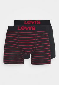 Svarta och röda randiga boxershorts med en bred svart midja som har Levi's-logotypen i röd färg. Mjuk, elastisk tyg med en slät yta.