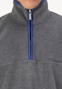 Gray fleece pullover with a high collar, featuring a blue zipper and accent. Embossed logo at the chest and textured fabric.