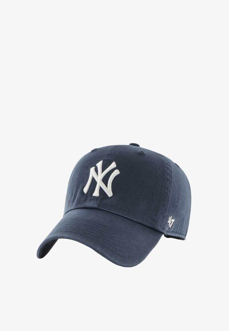 Navy blue cap made of cotton with a curved brim, featuring a white embroidered NY logo and subtle texture on the fabric.