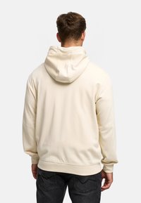 Felpa con cappuccio color crema, dal tessuto morbido, con maniche lunghe e polsini a costine. La parte posteriore presenta un design semplice e senza cuciture.