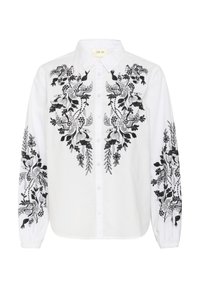 White shirt featuring intricate black embroidery of flowers and foliage; button-up design with long sleeves and a classic collar.