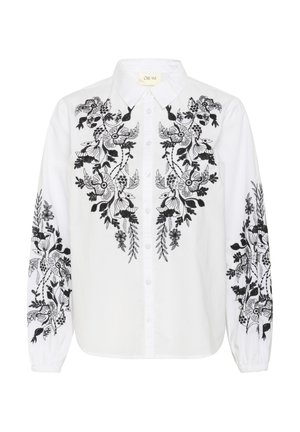 Witte blouse met ingewikkelde zwarte borduursels van bloemen en loof; knoopsluiting met lange mouwen en een klassieke kraag.