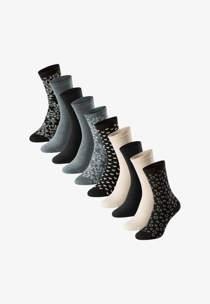 Cinq paires de chaussettes avec différents motifs, y compris des cœurs et des cercles, présentant des couleurs telles que le noir, le gris et le beige, fabriquées en mélange de coton.