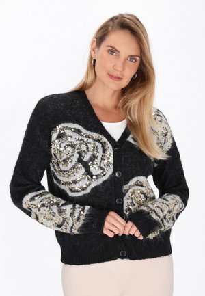 Cardigan nero con motivi floreali in paillettes argento e oro, scollo a V, chiusura con bottoni, texture morbida e orlo e polsini a coste.