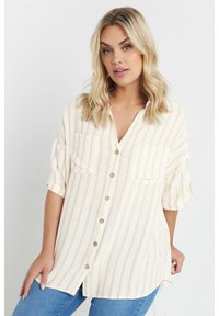 Knapp-up skjorta i ljus krämfärg med beige vertikala ränder, med två bröstfickor och korta ärmar, tillverkad av ett mjukt, texturerat tyg.