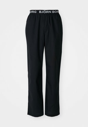 Black pants with an elastic waistband featuring a white "BJÖRN BORG" logo. Made of smooth fabric, they have a relaxed fit and straight legs.