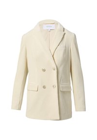 Einen cremefarbenen Cordblazer mit doppelt knöpfbarem Design, Reverskragen, zwei vorderen Taschen und Knopfverschluss. Genoppter, strukturierter Stoff.