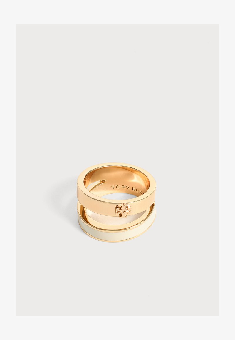 Δαχτυλίδι διπλής ζώνης σε χρυσό τόνο Tory Burch με μικρό έμβλημα λογότυπου στη πάνω ζώνη και λείο, γυαλιστερό φινίρισμα.