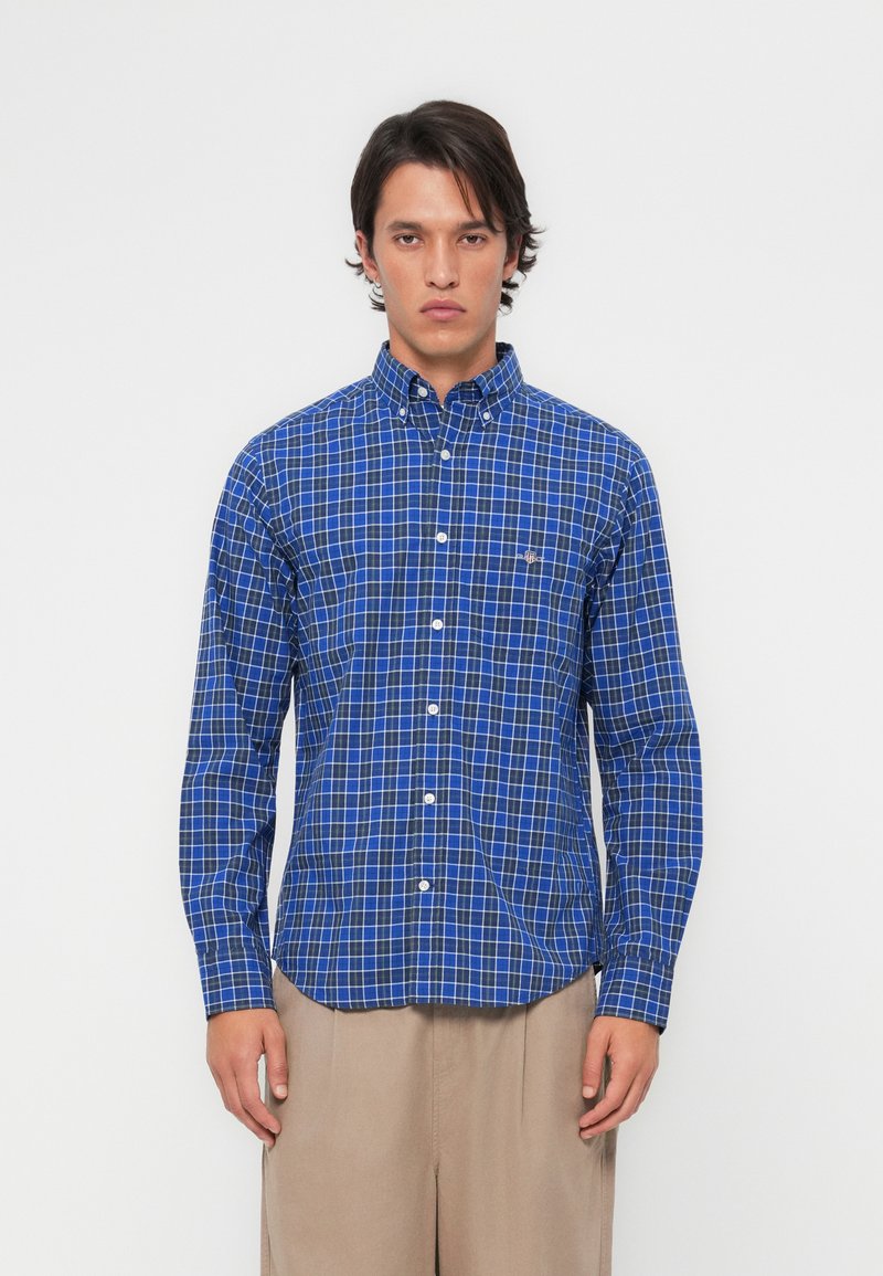 Blue and white checked long-sleeve shirt with a button-down collar and front placket, made of light fabric with a smooth texture.