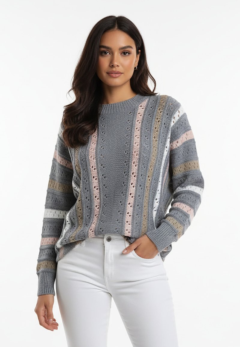 Sweter dziergany na drutach w kolorze szarym, z pionowymi pasami w pastelowym różu, bieli i beżu. Teksturowany wzorami ażurowymi, z okrągłym dekoltem.