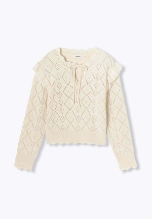 Un pull crème avec un motif en losanges, des accents en dentelle sur les épaules, un col à nouer et des bords festonnés aux poignets et à l'ourlet.