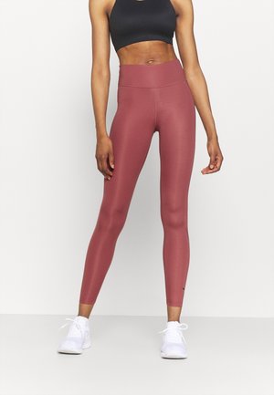 Leggings taille haute, ajustés et en rose doux, fabriqués à partir d'un matériau extensible, présentant un design sans coutures et un léger détail de logo.