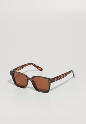 Brown tortoiseshell sunglasses with square frames and brown tinted lenses. Textured arms with visible pattern accents.