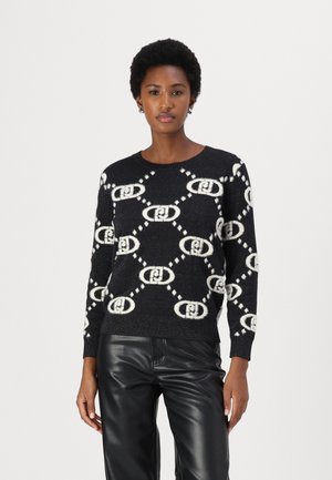 Zwarte sweater met een wit geometrisch patroon, ronde hals, lange mouwen en ribgebreide boorden. Gemaakt van een gestructureerd breimateriaal.
