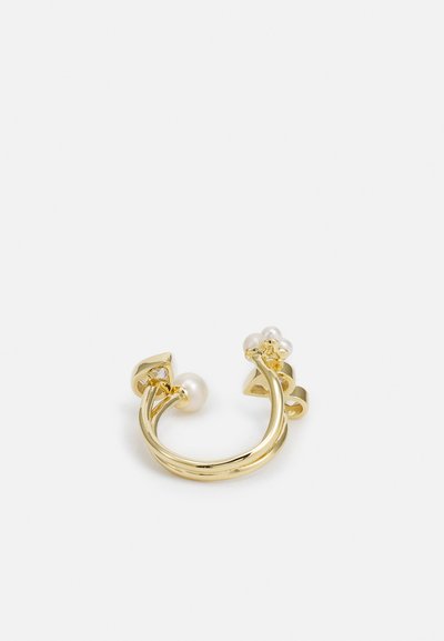 Gold metal ear cuff featuring a curved design, adorned with a single pearl and floral accents. Reflective finish and smooth texture.