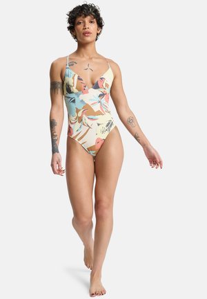 Jednoczęściowy strój kąpielowy z dekoltem w serek, ozdobiony kolorowym kwiatowym wzorem na jasnobeżowym tle. Cienkie ramiączka i wysokie wycięcia na nogi.