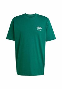 Green cotton t-shirt with short sleeves, crew neckline, and white printed logo on the left chest. Smooth texture, straight cut.