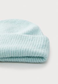 Light blue knitted beanie hat made of soft material, featuring a ribbed texture and a folded cuff at the bottom.