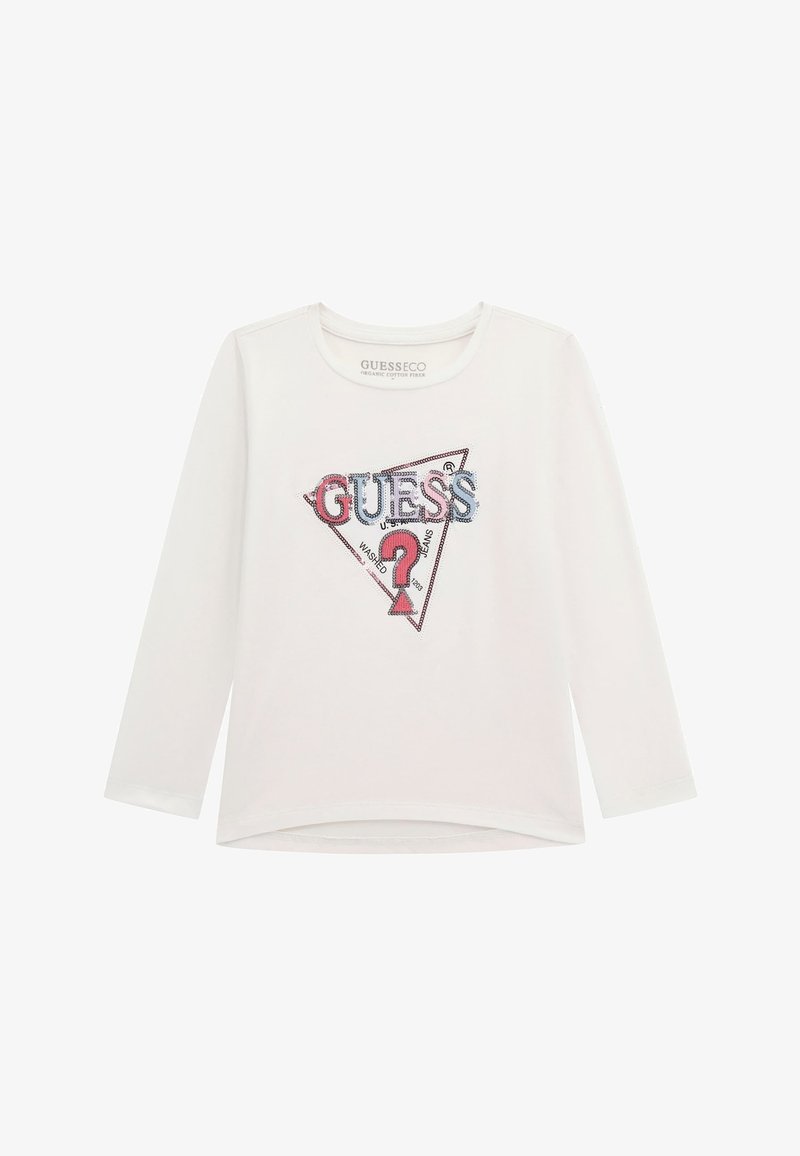 Fehér hosszú ujjú ing, amelyen egy háromszög alakú grafika található, rajta "GUESS" felirattal kék és rózsaszín színben, csillogó flitterekkel kiemelve, valamint egy kérdőjel részlettel.