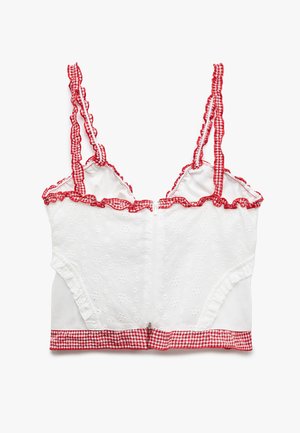 Hvid kort top med broderi, rød ternet kant og bølgede stropper. Besidder en frontlynlås og tætsiddende design.