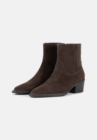 Brown suede ankle boots with a pointed toe and a modest block heel. Upper features smooth texture; no visible embellishments or patterns.