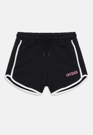 Crne kratke hlače s vezicom u struku, bijelim bočnim prugama i ružičastim izvezenim logotipom "GUESS" na donjoj desnoj strani. Mekani tekstura tkanine.