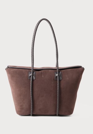 Brown suede tote bag with braided dark brown handles, featuring a spacious design and minimal hardware accents. Textured finish.