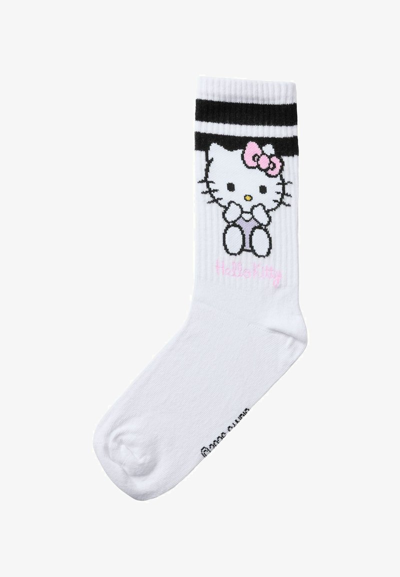 Chaussette blanche mi-mollet avec deux rayures noires et un personnage Hello Kitty assis avec un nœud rose près du haut du revers.