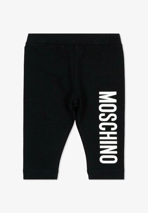 Czarne spodnie dla małego dziecka z elastycznym pasem i pionowym białym napisem „MOSCHINO” na prawej nodze.