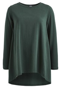Maglia lunga verde scuro con scollatura rotonda, vestibilità rilassata e orlo asimmetrico. Realizzata in un tessuto morbido con una superficie liscia.