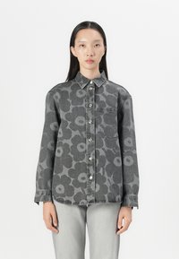Gray denim shirt with large floral pattern, button front, collar, and single pocket. Long sleeves with buttoned cuffs. Pair with gray jeans.