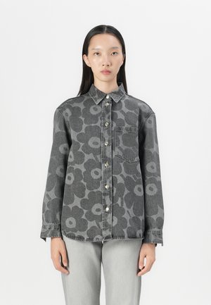 Gray denim shirt with large floral pattern, button front, collar, and single pocket. Long sleeves with buttoned cuffs. Pair with gray jeans.